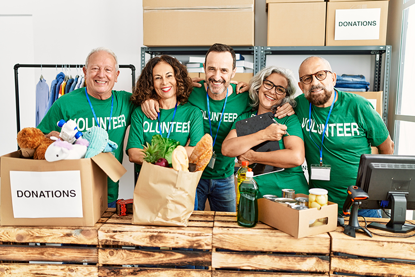 Group of middle age volunteers smiling happy and hugging